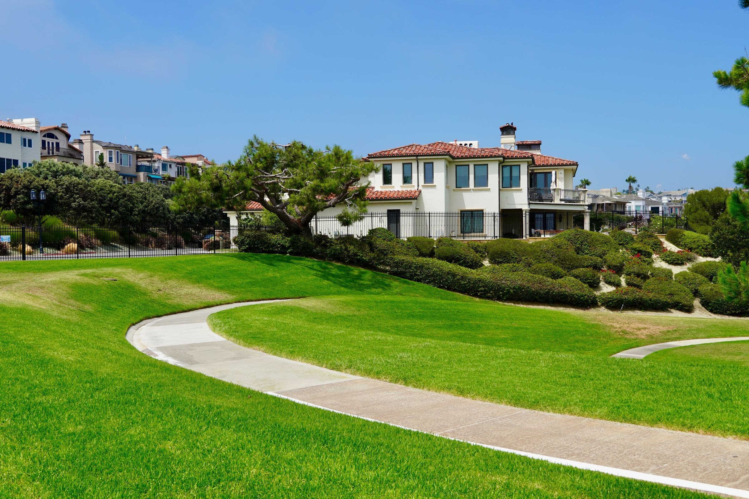 A picturesque suburban neighborhood with Mediterranean-style homes and lush green lawns, the kind of North County setting our movers work in around Vista, CA